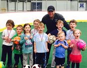 Children Standing With Soccer Coach